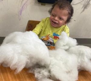 Child playing with cotton ילד משחק עם צמר גפן